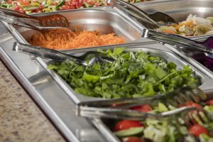 chef standing behind full lunch service station