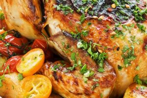 Whole roasted chicken with vegetables herbs and fruits. Shallow dof.