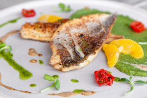 Closeup breakfast with Turkish coffee in cezve on wooden stand, porcelain cup with sugar cubes served on table in restaurant, reserved plate. oncept breakfast at luxury hotel