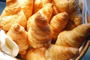 pile of croissant bread on buffet line
