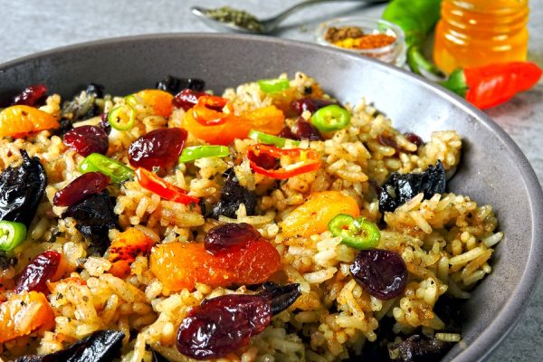 Spicy rice with spices and dried fruits. Vegan bowl. Healthy eating rice with spices. Food for weight loss.
